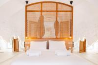 A bed or beds in a room at Faos Exclusive Suites