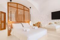 A bed or beds in a room at Faos Exclusive Suites