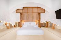 A bed or beds in a room at Faos Exclusive Suites