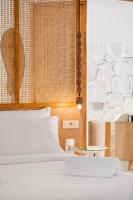 A bed or beds in a room at Faos Exclusive Suites
