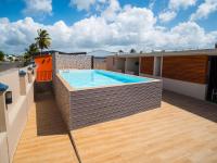 a swimming pool on the roof of a house at T2 jacuzzis et piscine au centre ville de Port-Louis in Port-Louis