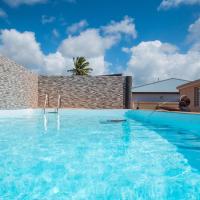 a man sitting in a swimming pool at T2 jacuzzis et piscine au centre ville de Port-Louis in Port-Louis