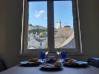 a table with food and wine glasses and a window at Le Charles VII in Chinon