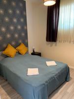 A bed or beds in a room at Bazsalikom Vendégház