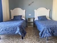 A bed or beds in a room at Hotel Medina Centro