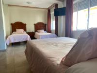 A bed or beds in a room at Hotel Medina Centro