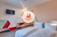 a bedroom with a bed and a sign that reads member index at MEININGER Hotel Heidelberg Hauptbahnhof in Heidelberg