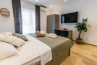 Postel nebo postele na pokoji v ubytování Apartments KIWI