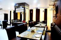 een restaurant met tafels en stoelen in een kamer bij Taraji Resort in Ayodhya