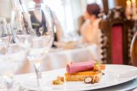 a plate of food on a table with wine glasses at Schloss Purschenstein in Neuhausen