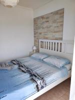 A bed or beds in a room at Sea Breeze Apartment