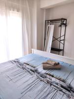 A bed or beds in a room at Sea Breeze Apartment