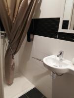 a bathroom with a sink and a shower curtain at LE PATIO in Millau