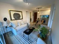 a living room with a white couch and a table at Departamento Pucon in Pucón