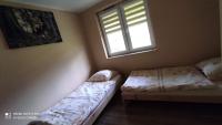 Posteľ alebo postele v izbe v ubytovaní Domki "Nad Rzeką Solinką" Tomasz Pasławski