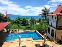 a swimming pool with a view of the ocean at Moonstone Studio in Haad Rin