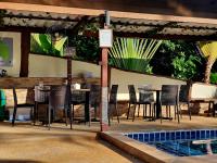a restaurant with chairs and a table and a swimming pool at Moonstone Studio in Haad Rin