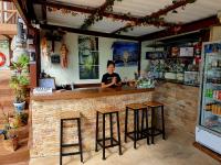 a woman sitting at a bar in a restaurant at Moonstone Studio in Haad Rin