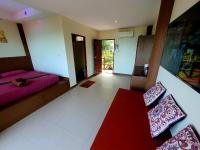 a room with two beds and a table and chairs at Moonstone Studio in Haad Rin