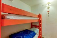 a bedroom with two bunk beds with blue bags on them at Pégase Phénix in Le Corbier