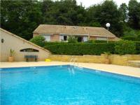 a large blue swimming pool in front of a house at LE GECKO GITE in Saint-Martin-dʼArdèche