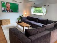 a living room with a couch and a tv at Péniche Santa Julia au port de Chantilly Insolys in Saint-Leu-dʼEsserent