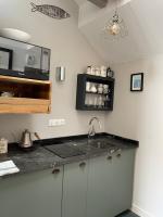 a kitchen with a sink and a microwave at Kermaria Studio Suite in Pont-Aven