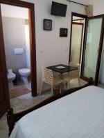 A bed or beds in a room at B&B Lo Scrigno del Salento