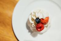 a small dessert with berries on a white plate at Hotel Troyer in Trojanovice