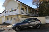 a small car parked in front of a house at Marco Polo in Horbourg