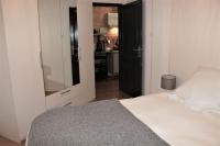 a bedroom with a white bed and a mirror at Marco Polo in Horbourg