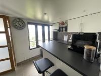 a kitchen with a black counter top in a room at Appartement T2, très cosy, vue panoramique in Saint-Cyr-lʼÉcole