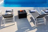 two chairs and a table next to a pool at Holiday home Ivana - private pool in Privlaka