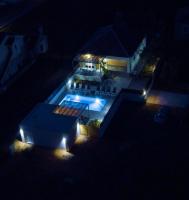 a house with a swimming pool at night at Holiday home Ivana - private pool in Privlaka
