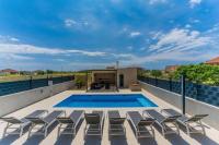 a patio with chairs and a swimming pool at Holiday home Ivana - private pool in Privlaka