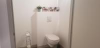 a white bathroom with a toilet in a room at Le jardin de l&#39;horloge in La Rochelle
