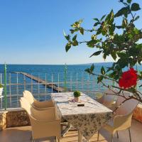 a table and chairs with a view of the ocean at Hotel Oasis - Beach Access in Balchik