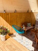 a patio with a couch and a chair and a table at Gîte « Le Patio » in Montfarville