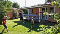 a group of children playing with a soccer ball in a yard at Le Hameau des Genets in Montlaur