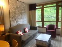 a living room with a couch and a chair at Appartement Les Arcs 1800, 2 pièces, 4 personnes - FR-1-346-318 in Arc 1800