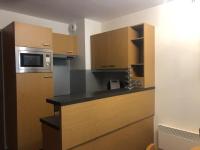 a kitchen with wooden cabinets and a microwave at Appartement Les Arcs 1800, 2 pièces, 4 personnes - FR-1-346-318 in Arc 1800