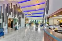 a lobby with a large chandelier hanging from the ceiling at Kyriad Hotel Meaux in Meaux