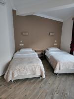 A bed or beds in a room at Mersu A'la Konak Otel