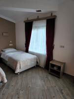 A bed or beds in a room at Mersu A'la Konak Otel