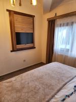 A bed or beds in a room at Mersu A'la Konak Otel