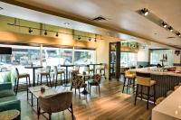 a restaurant with tables and chairs and a bar at Holiday Inn Toronto Downtown Centre by IHG in Toronto