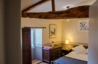 a bedroom with a bed and a dresser at La Pause Céleste in Ordonnac