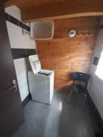 a small room with a stove and a chair at Marmotte - Apartment near the cable car in La Grave in La Grave