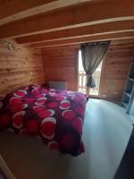 a bedroom with a large bed in a log cabin at Marmotte - Apartment near the cable car in La Grave in La Grave