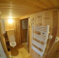 a small bathroom with a toilet in a room at Cabane et potager sud Cévennes, jacuzzi en option in Roquedur